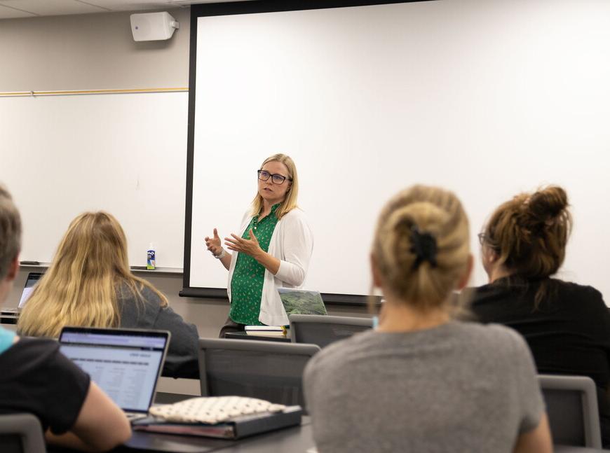 Social Work Program Director Toni Jensen in the front of a classroom teaching.